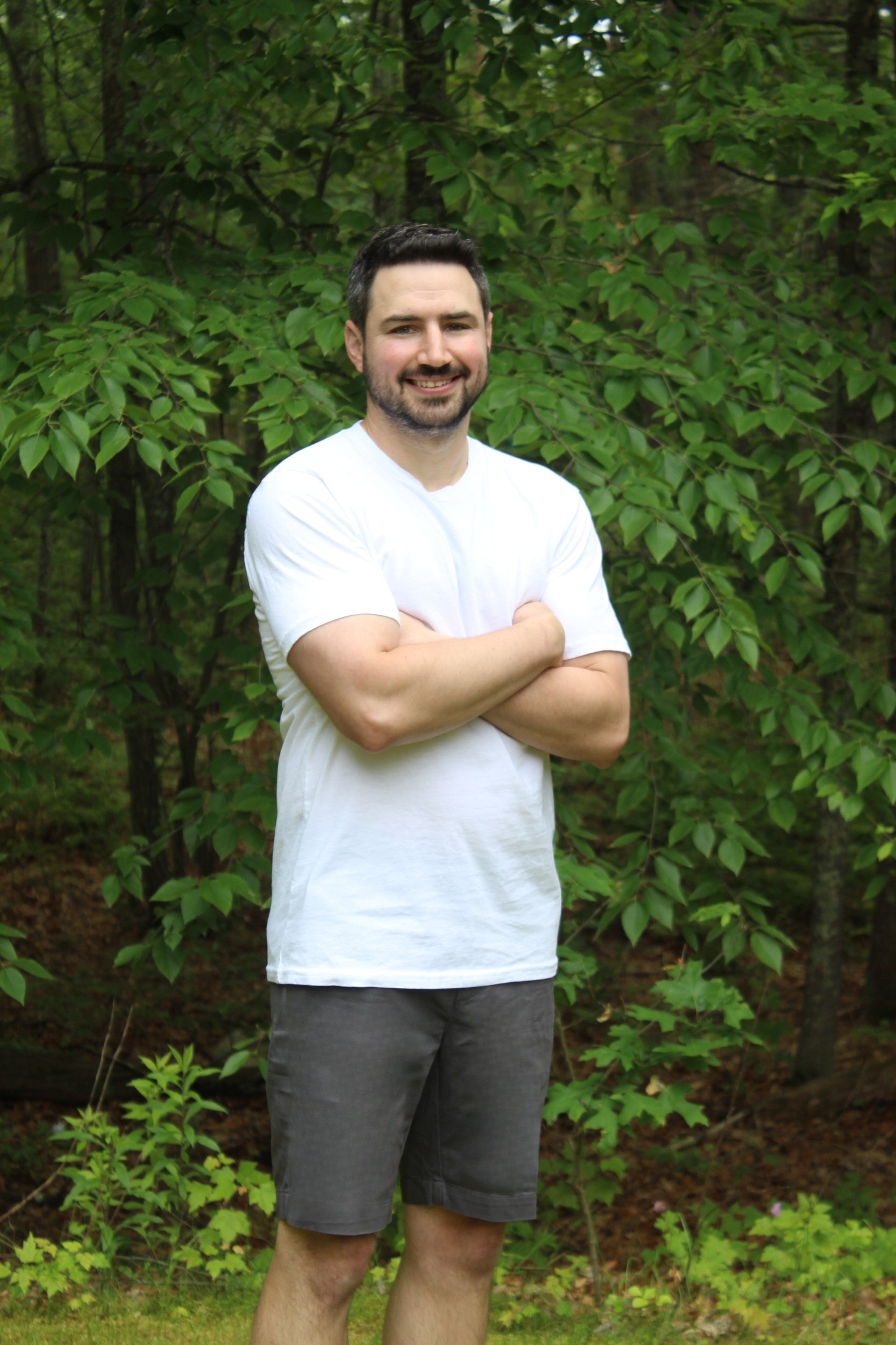 Man wearing a Premium 100% Organic Cotton Regular Tee in a natural outdoor setting.